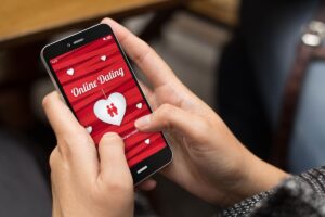 45968865 - online love concept: girl using a digital generated phone with dating site on the screen. all screen graphics are made up.